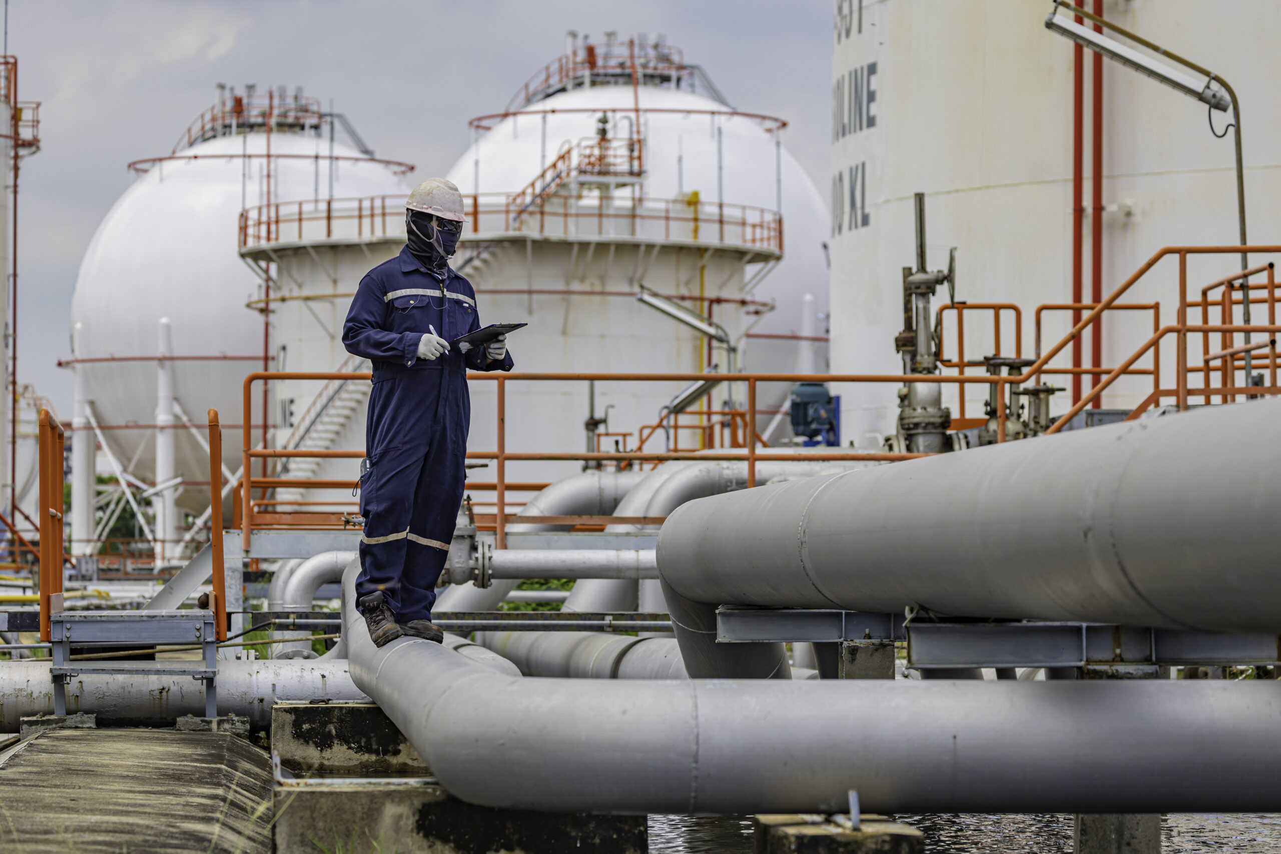 Male worker inspection at steel long pipes and pipe elbow in sta